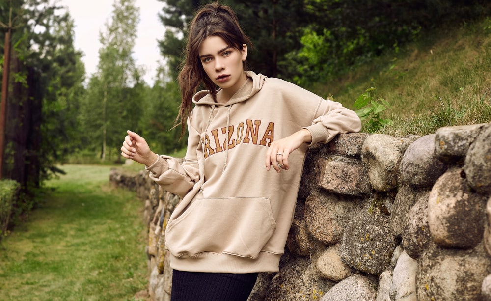 Gorgeous woman in a cozy personalized hoodie with inscription for fall 2025
