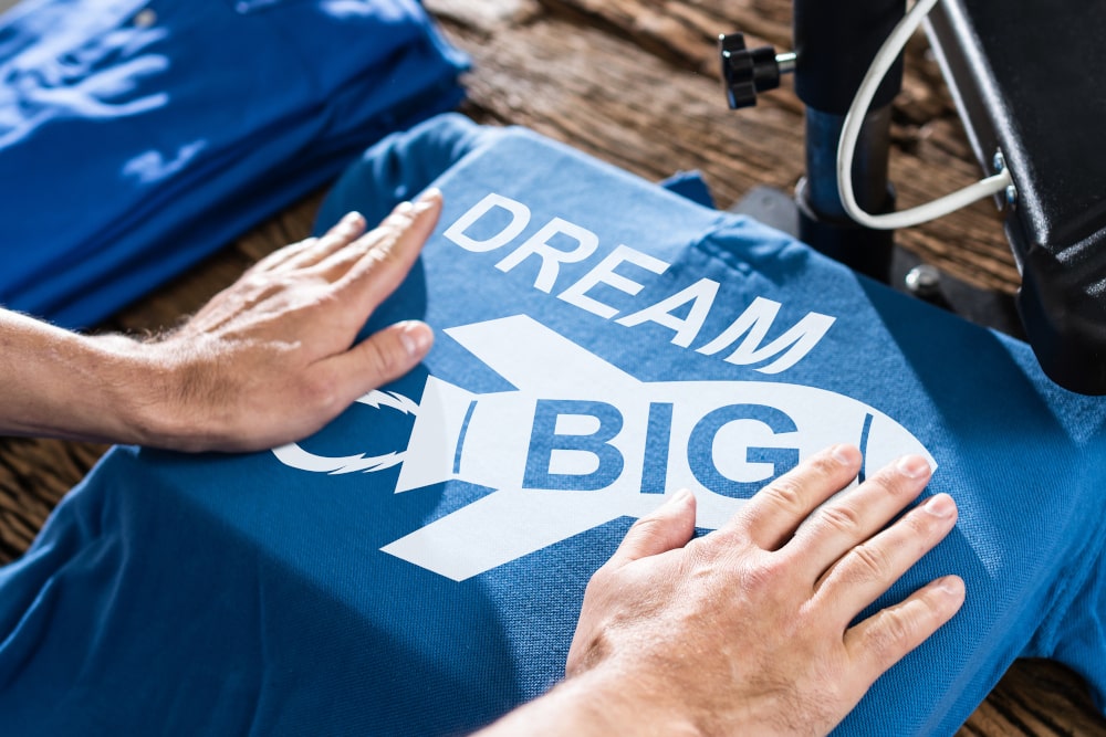 Custom logo being printed on a T-shirt in a Toronto workshop